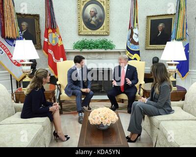 Washington, United States Of America. 11th Oct, 2017. U.S. President Donald Trump and First Lady Melania Trump during a meeting with Canadian Prime Minister Justin Trudeau and his wife Sophie Grégoire Trudeau, left, in the Oval Office of the White House October 11, 2017 in Washington, DC. Credit: Planetpix/Alamy Live News