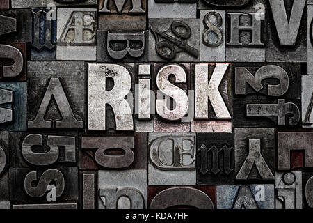 The word Risk made from old metal letterpress letters Stock Photo