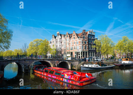 Amsterdam, Netherlands - April 20, 2017: The excursion ship on the canal in Amsterdam Stock Photo