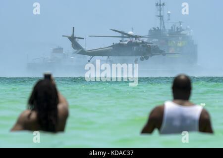 Spectators on the beach view an aerial demonstration during the National Salute to Americas Heroes Air and Sea Show May 28, 2017 in Miami Beach, Florida. Stock Photo