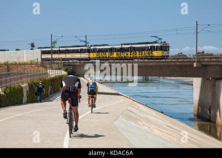 Los Angeles Metro Rail going over bike path along Los Angeles River, Long Beach, California, USA Stock Photo