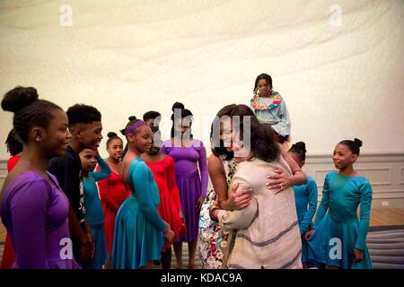 U.S. First Lady Michelle Obama hugs Savoy Elementary School teacher Carol Foster after a dance performance by Turnaround Arts Program students at the Smithsonian American Art Museum Renwick Gallery May 13, 2016 in Washington, DC. Stock Photo