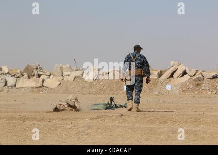 An Iraqi Federal Police officer sets up his weapon during a sniper training course with U.S. soldiers June 7, 2017 in Mosul, Iraq. Stock Photo