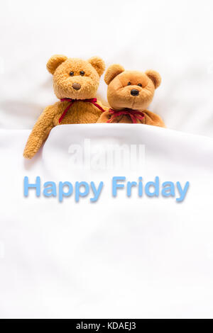 Teddy Bear lying with message '  Happy  Friday ' Stock Photo