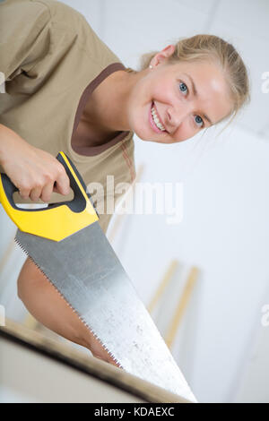 using a manual saw Stock Photo