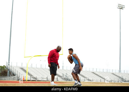 Coach training a high school athlete. Stock Photo