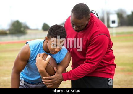 Coach training a high school athlete. Stock Photo