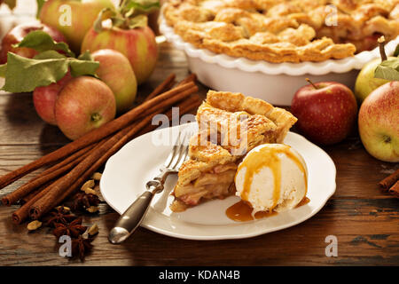 Piece of an apple pie with ice cream on a plate Stock Photo