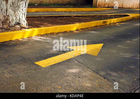 Parking lot entrance yellow arrow sign on Paseo de Montejo avenue in Merida, Mexico Stock Photo