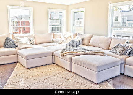 Comfy couch with pillows surrounded by houseplants Stock Photo - Alamy