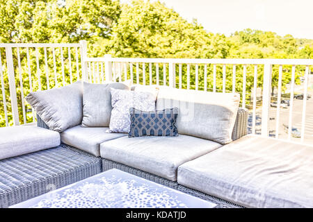 View of comfortable modern corner couch sofa with many pillows outside on loft balcony Stock Photo