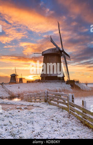 Traditional Dutch windmills on a beautiful winter morning at sunrise. Stock Photo
