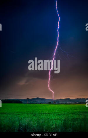 Thunderstorm with lightning in green meadow. Nature composition Stock Photo