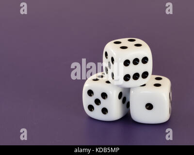 Closeup of three white dices lying on a table Stock Photo