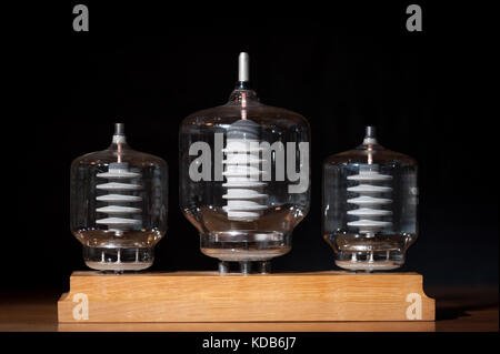 Three old vacuum transmitting tubes in front of a black background Stock Photo
