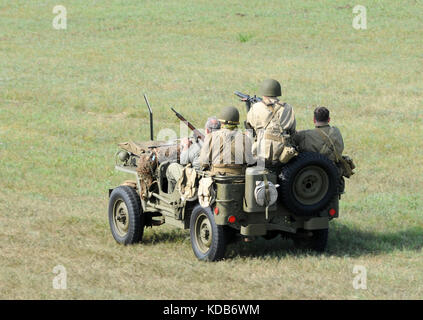 World War II era soldiers riding on a battlefield Stock Photo