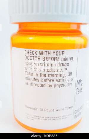 Orange medicine bottle with label warning. Stock Photo