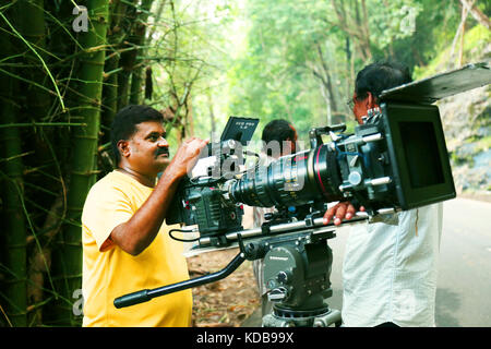 Video camera operator on nature background, film shooting spot Stock Photo