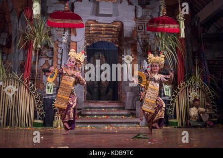 Traditional Balinese Legong dancers performing in a theater in Ubud, Bali, Indonesia. Stock Photo