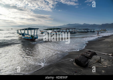 Secured boats against the increasing waves and tide in Gili Air, Gili Islands, Indonesia. Stock Photo