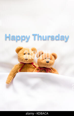 Teddy Bear lying with message '  Happy  Thursday' Stock Photo