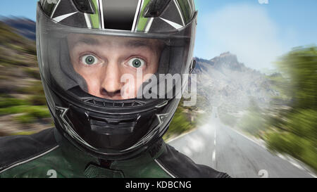 Biker in a helmet with wide open eyes Stock Photo