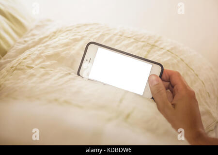 Smartphone with blank display on a pillow Stock Photo