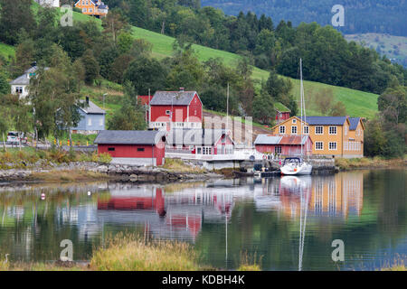 Houses and farms on the side of the Nordfjorden fjord near the village of Olden in Norway