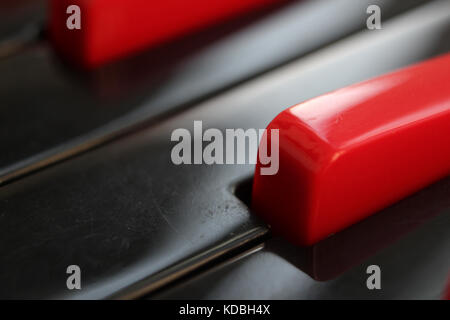 Closeup of black and red keys of melodica keyboard. Stock Photo