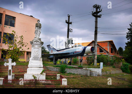 Romanian Air Force Mig 21 jet fighter on display at a memorial in the village of Balaci in Romania. Stock Photo
