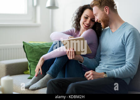 Young couple using digital tablet at home Stock Photo