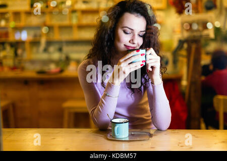 Beautiful woman drinking coffee in coffee shop Stock Photo