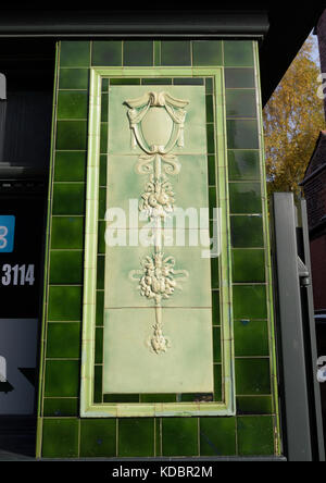 Green ceramic tiles on outside wall of former temperance billiard hall in bury lancashire uk Stock Photo