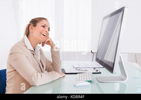 Portrait Of Young Businesswoman Using Computer In The Office Stock Photo