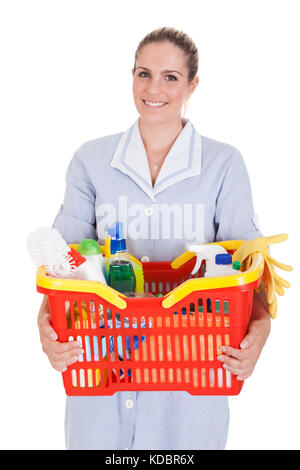 Female Cleaner Holding Detergent And Chemical Supplies In Basket Over White Background Stock Photo