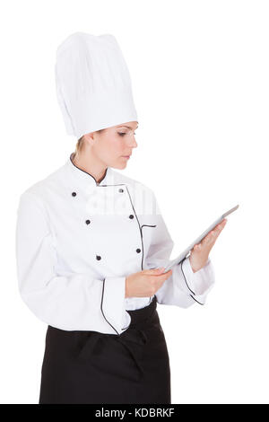 Portrait Of Female Chef Using Digital Tablet On White Background Stock Photo