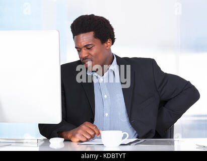 Portrait Of A Businessman Suffering From Back Pain Stock Photo