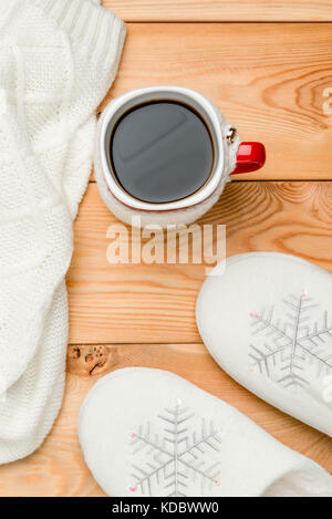 hot coffee and warm clothes on wooden boards top view Stock Photo