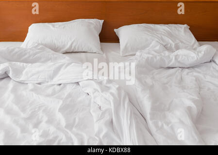 crumpled bed white linen in the morning to the hotel after the guests leave Stock Photo