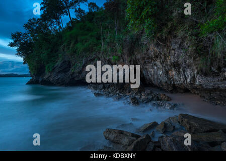 A gloomy seascape - the shore, rocks and running water Stock Photo