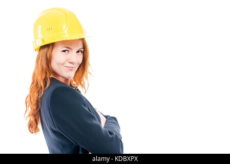 Portrait of a female architect in a yellow helmet, space on the right on a white background Stock Photo