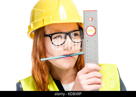 portrait of a concentrated foreman with a ruler and a pencil in the teeth isolated Stock Photo