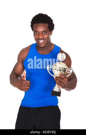Portrait Of Happy African Athlete Over White Background Holding Trophy Stock Photo