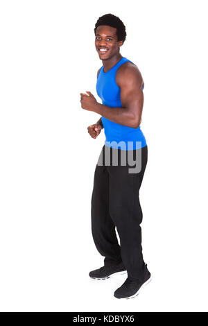 Portrait Of A African Young Man Jogging Over White Background Stock Photo