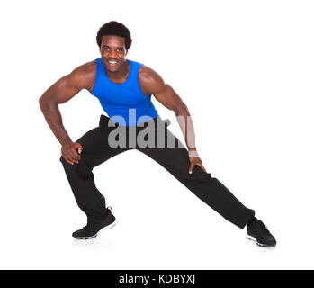 Portrait Of Happy African Young Man Exercising Over White Background Stock Photo