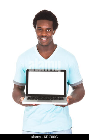 Happy Young African Man Using Laptop Isolated Over White Background Stock Photo