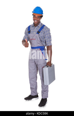 Portrait Of A Young African Craftsman Showing His Thumb Up Over White Background Stock Photo