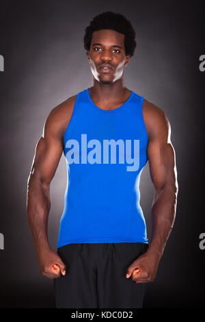 Portrait Of Young African Man Over Black Background Stock Photo