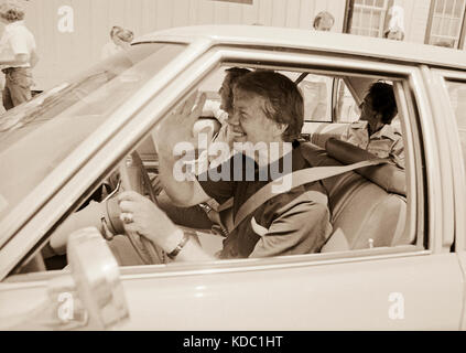 1976 Democratic presidential nominee Jimmy Carter takes his running mate, Walter 'Fritz' Mondale and wife, Joan on a ride around carter's home town of Stock Photo