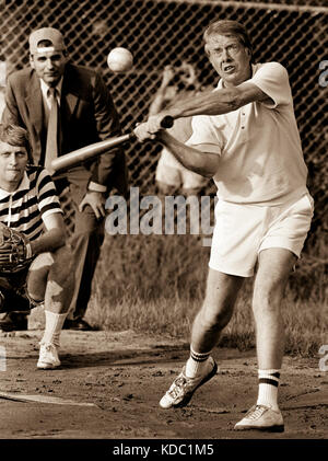Carter at bat during a softball game at Plains High School. The umpire is consumer advocate and future five-time presidential candidate Ralph Nader. Stock Photo